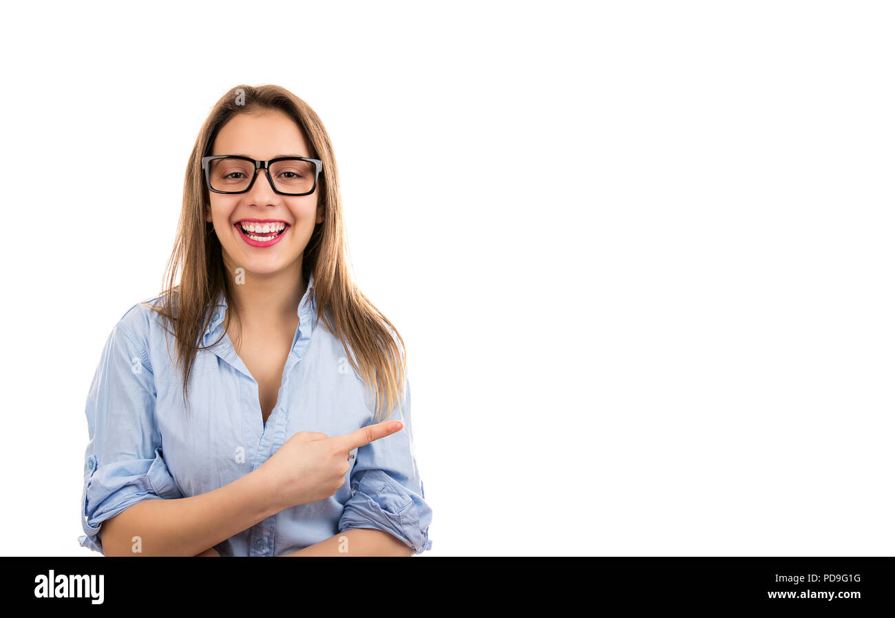 Happy teen young woman laughing and pointing away with forefinger isolated on white background Stock Photo