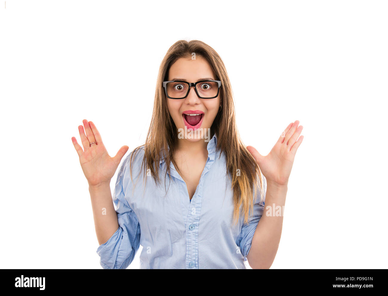Young happy woman in glasses with mouth opened looking amazed and excited with victory isolated on white background Stock Photo