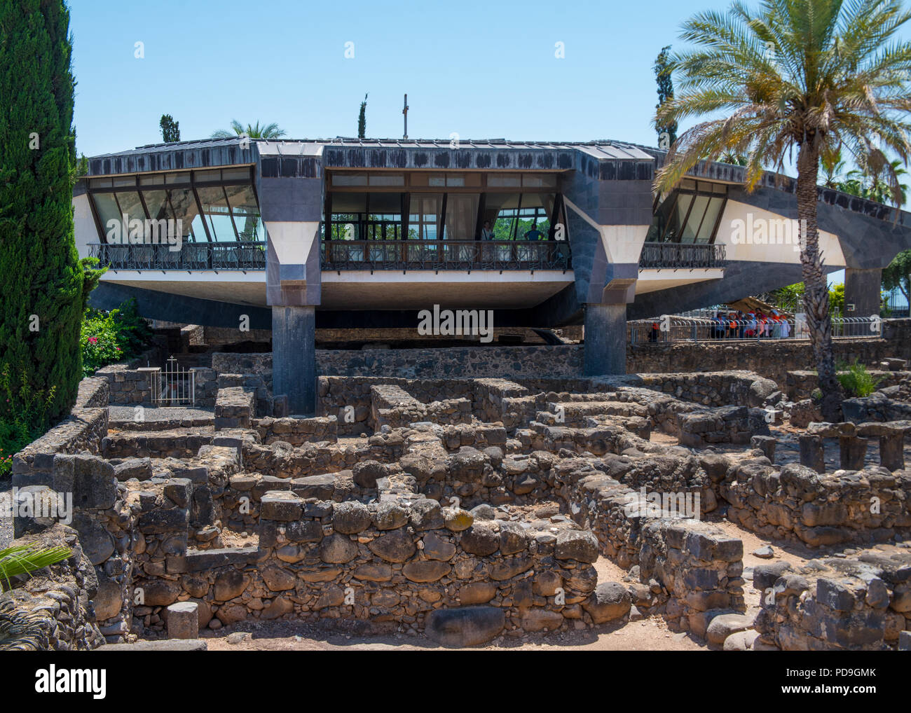 Capernaum, Israel   May 18  2018:Modern church over the  ruins of the dark basalt rock village of Capernaum, on the shore of the Sea of Galilee, where Stock Photo