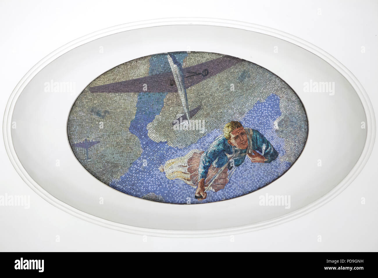 Parachutist jumping from the glider depicted in the ceiling mosaic designed by Soviet artist Alexander Deyneka in the Mayakovskaya metro station in Moscow, Russia. One of the mosaics from the set entitled Twenty-four Hours in the Soviet Sky assembled by Russian mosaic master Vladimir Frolov in the 1930s. Stock Photo
