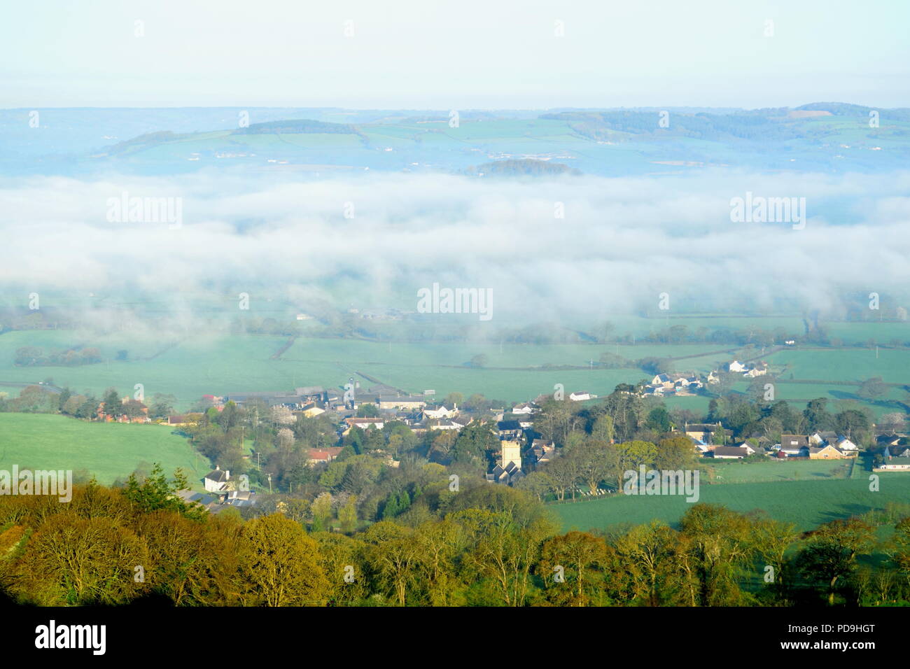 Misty morning over village of Musbury and Axe Valley in East Devon AONB (Area of Outstanding Natural Beauty) Stock Photo