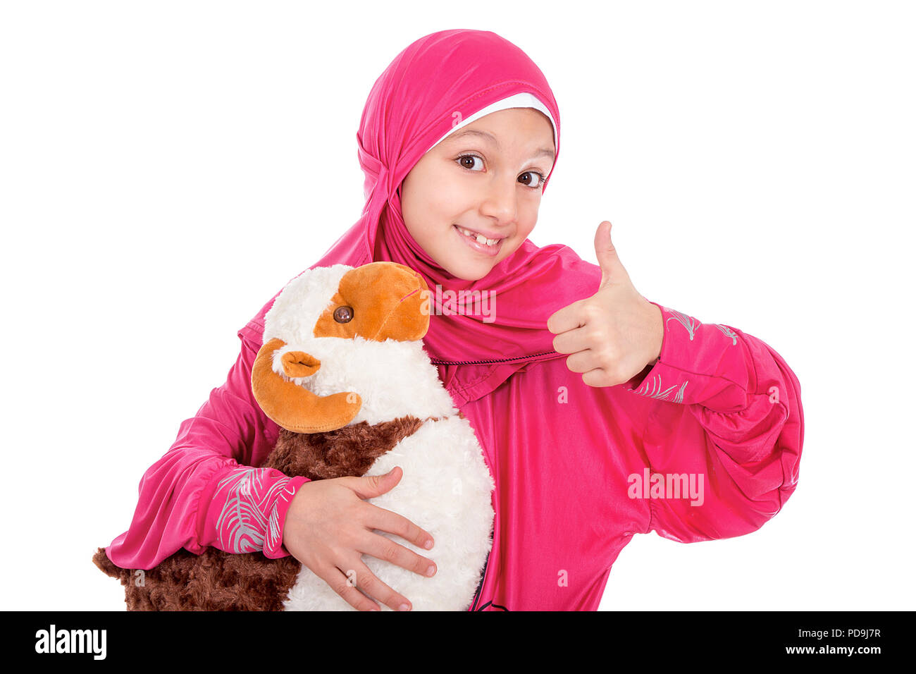 Happy little girl playing with her sheep toy - celebrating Eid ul Adha - Happy Sacrifice Feast Stock Photo
