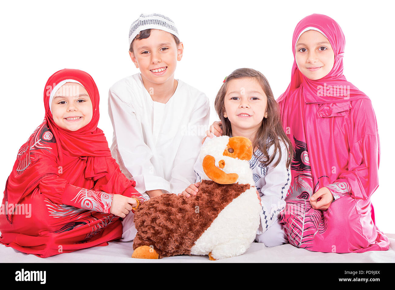 Happy little Muslim kids playing with sheep toy - celebrating Eid ul Adha - Happy Sacrifice Feast Stock Photo