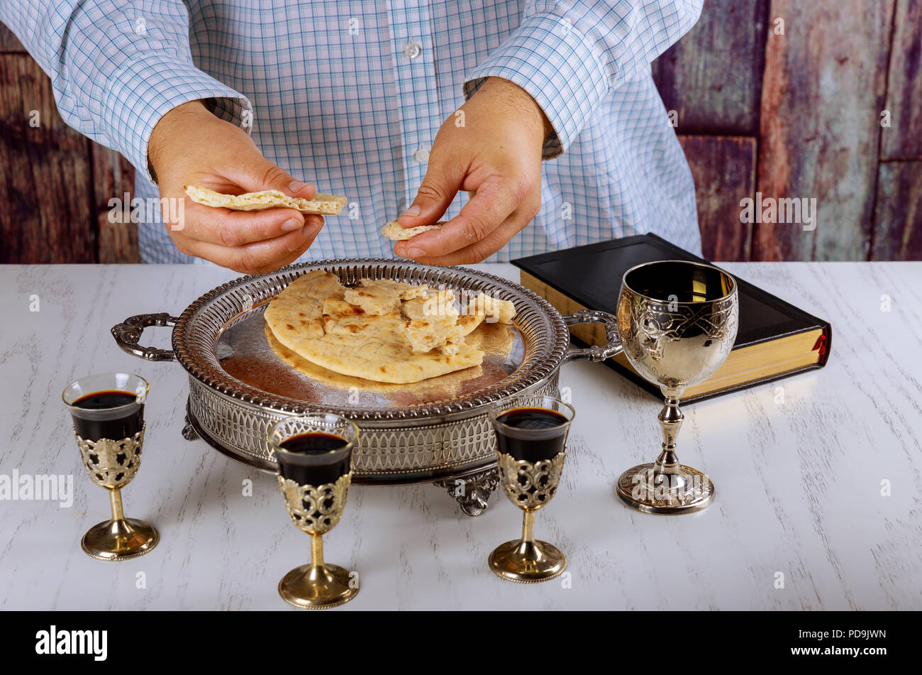 Communion still life wine, bread and Bible, breaking the bread in the