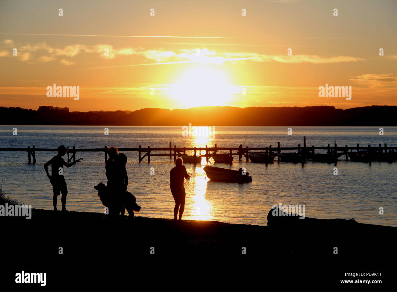 People enjoying the cooler evening at a beach in Southern Denmark Stock Photo
