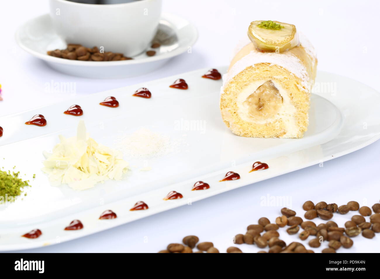 Rolled sponge cake filled with jam and vanilla Stock Photo Alamy