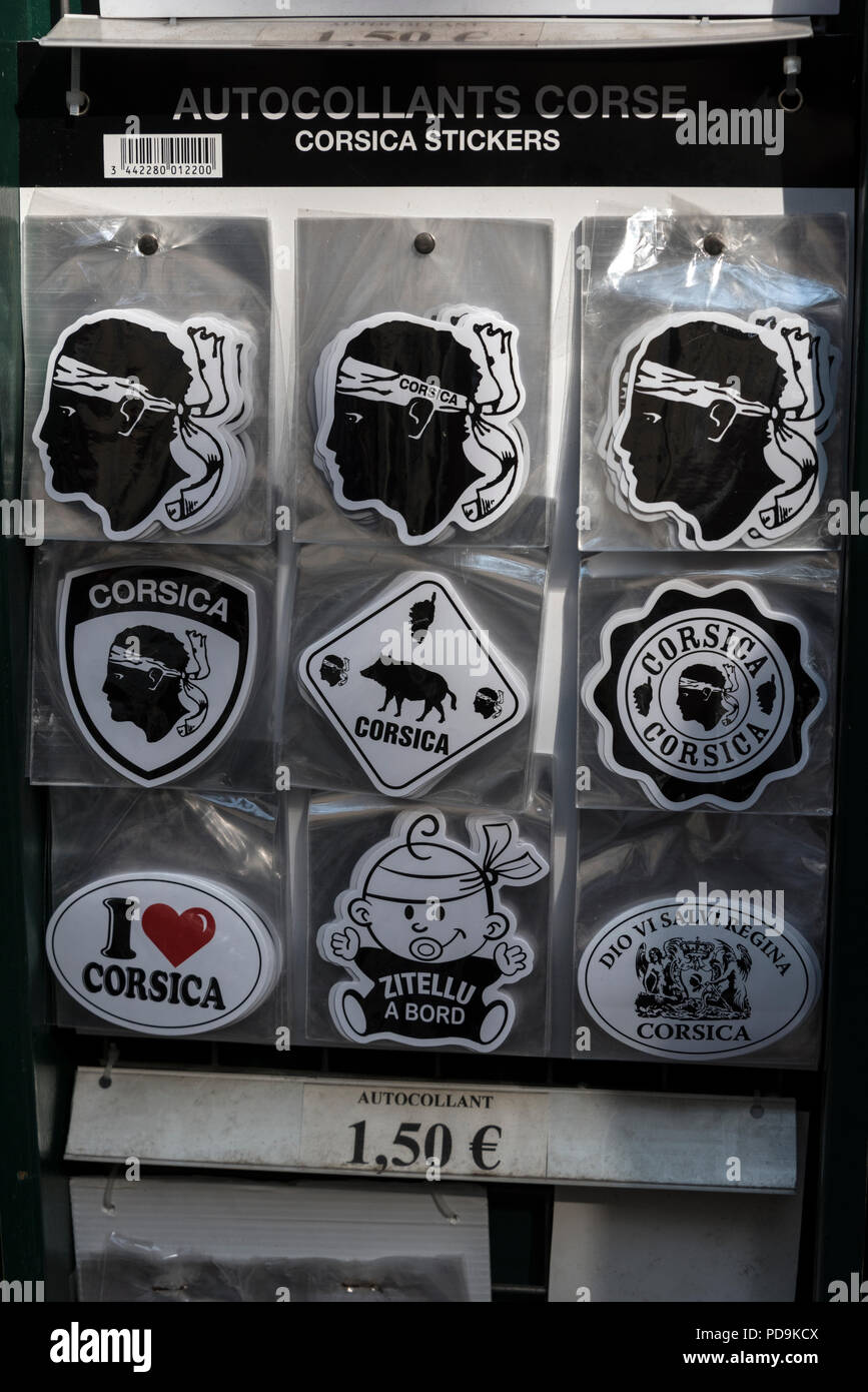 Tourist souvenir stickers showing the moor's head, that appears on the  national flag of Corsica. Th head with a white bandeau was adopted by  Pasqual Stock Photo - Alamy