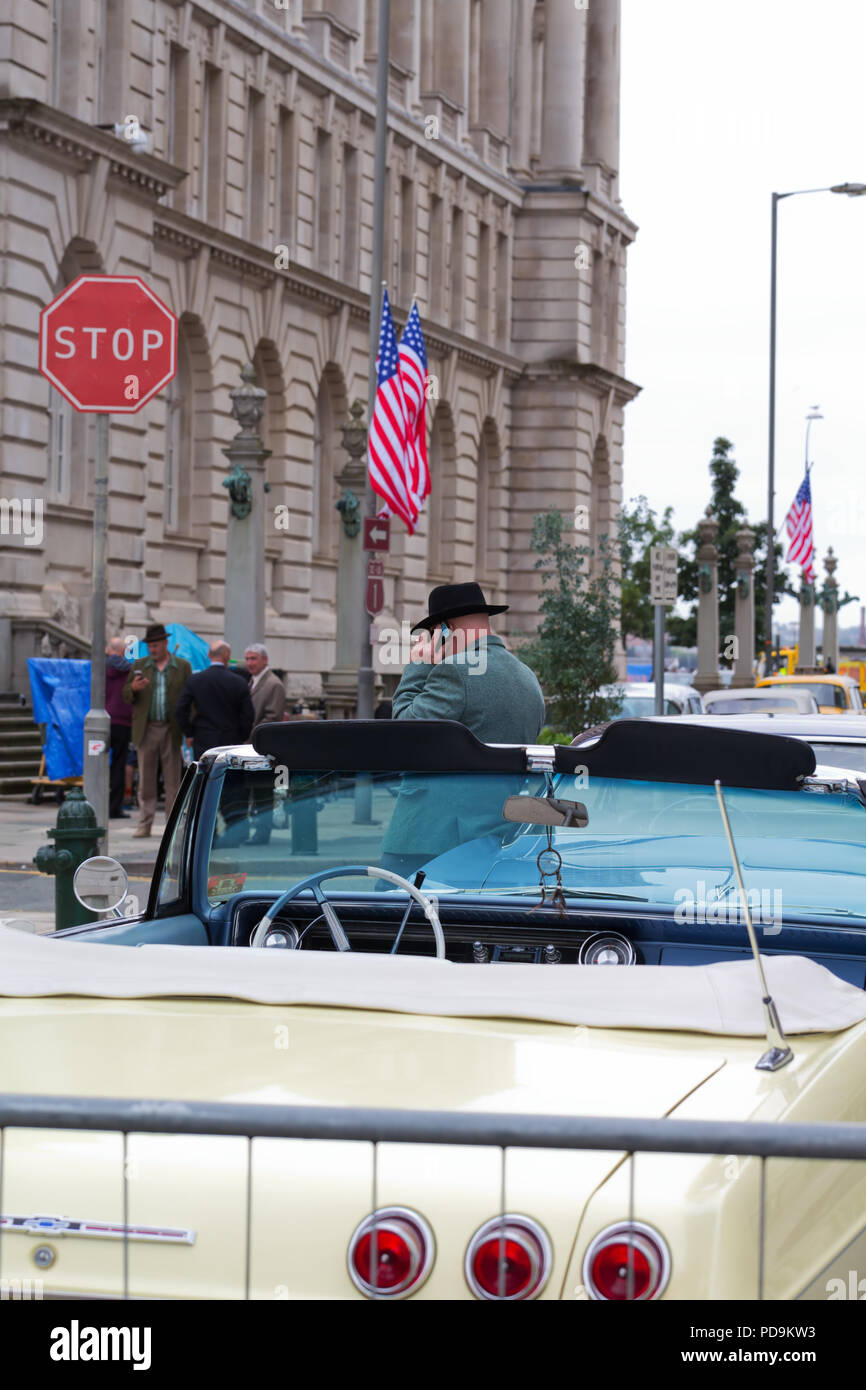 American vintage classic cars and actors on a film set in Liverpool UK. Stock Photo