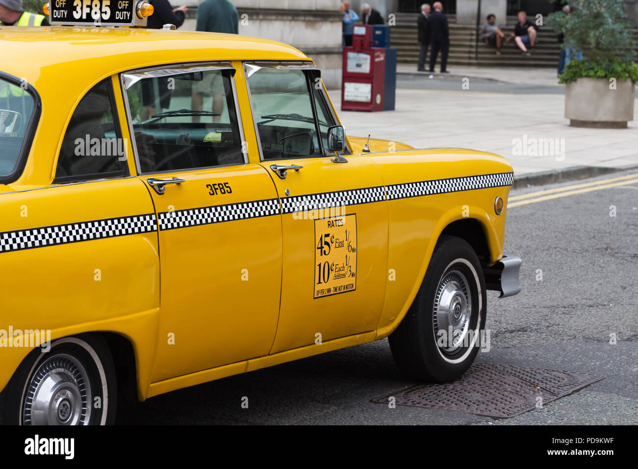 Vintage Washington DC yellow taxi cab photographed in Liverpool UK whilst being filmed as part of a major TV series. Stock Photo