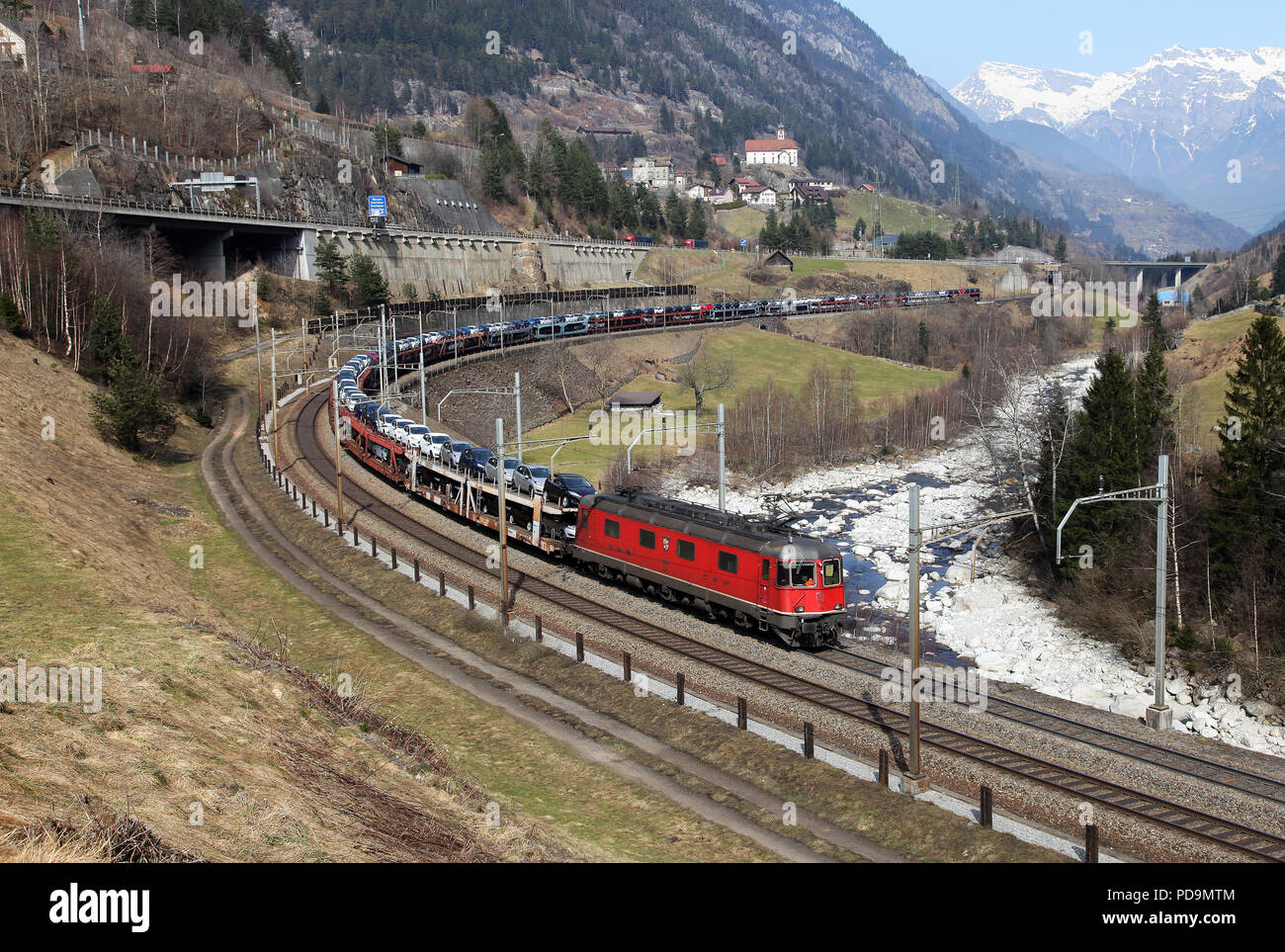 A freight heads round Wassen curve on the Gotthard route 20.3.15 Stock Photo