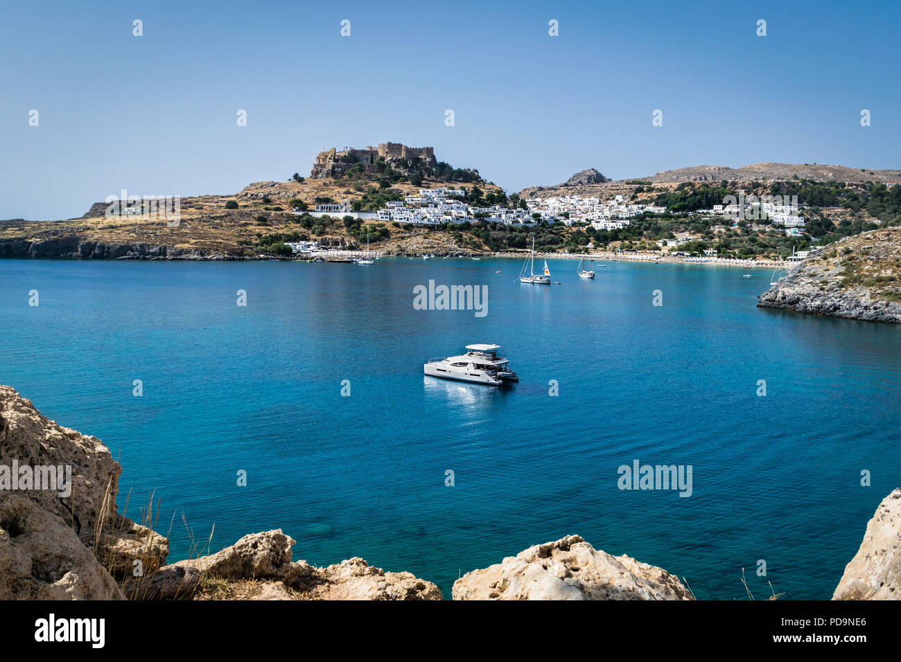 This is a picture of boats anchored in Lindos Harbour on the Greek Island of Rhodes Stock Photo