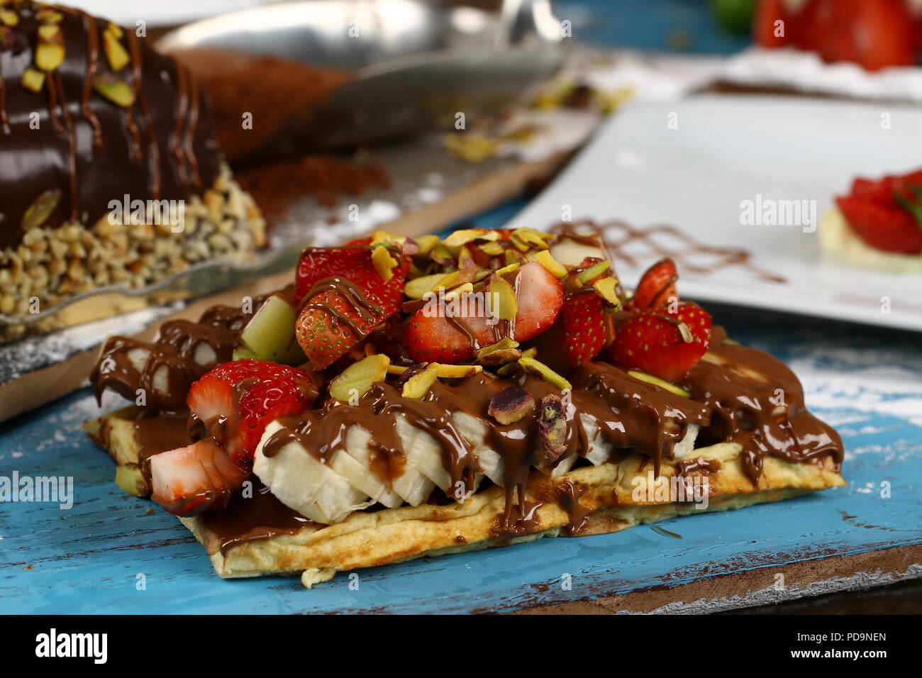 Waffle with chocolate sauce and banana, kiwi strawberry fruits Stock ...