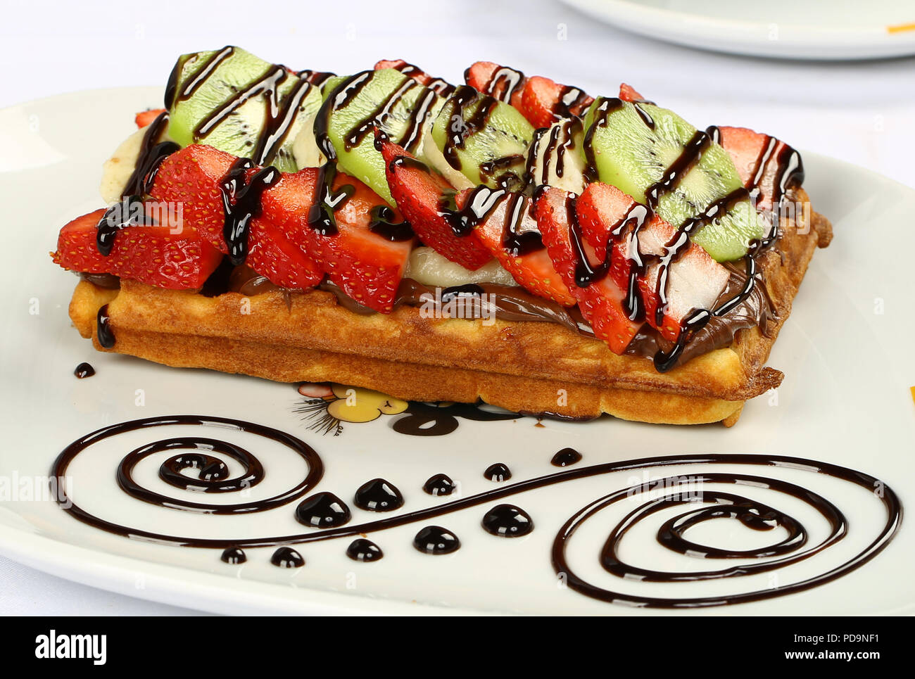 Waffle with chocolate sauce and banana, kiwi strawberry fruits Stock ...