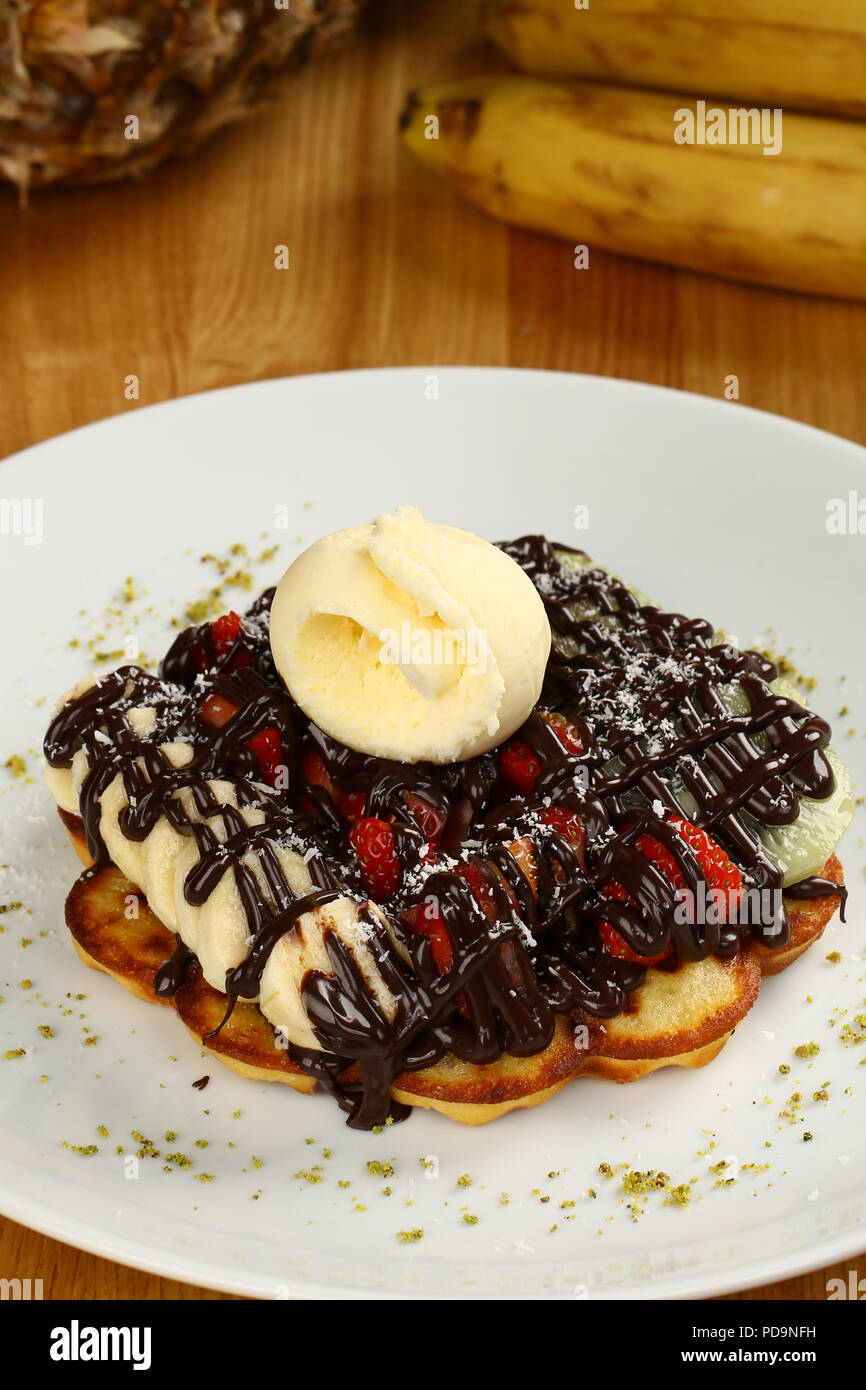 Waffle with chocolate sauce and banana, kiwi strawberry fruits Stock ...