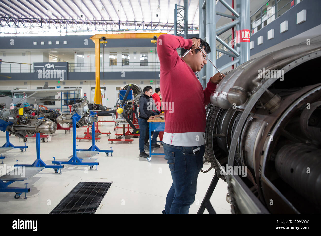Students practice maintenance on various types of aircraft engines for the National Aeronautics University’s skilled technician training program at th Stock Photo