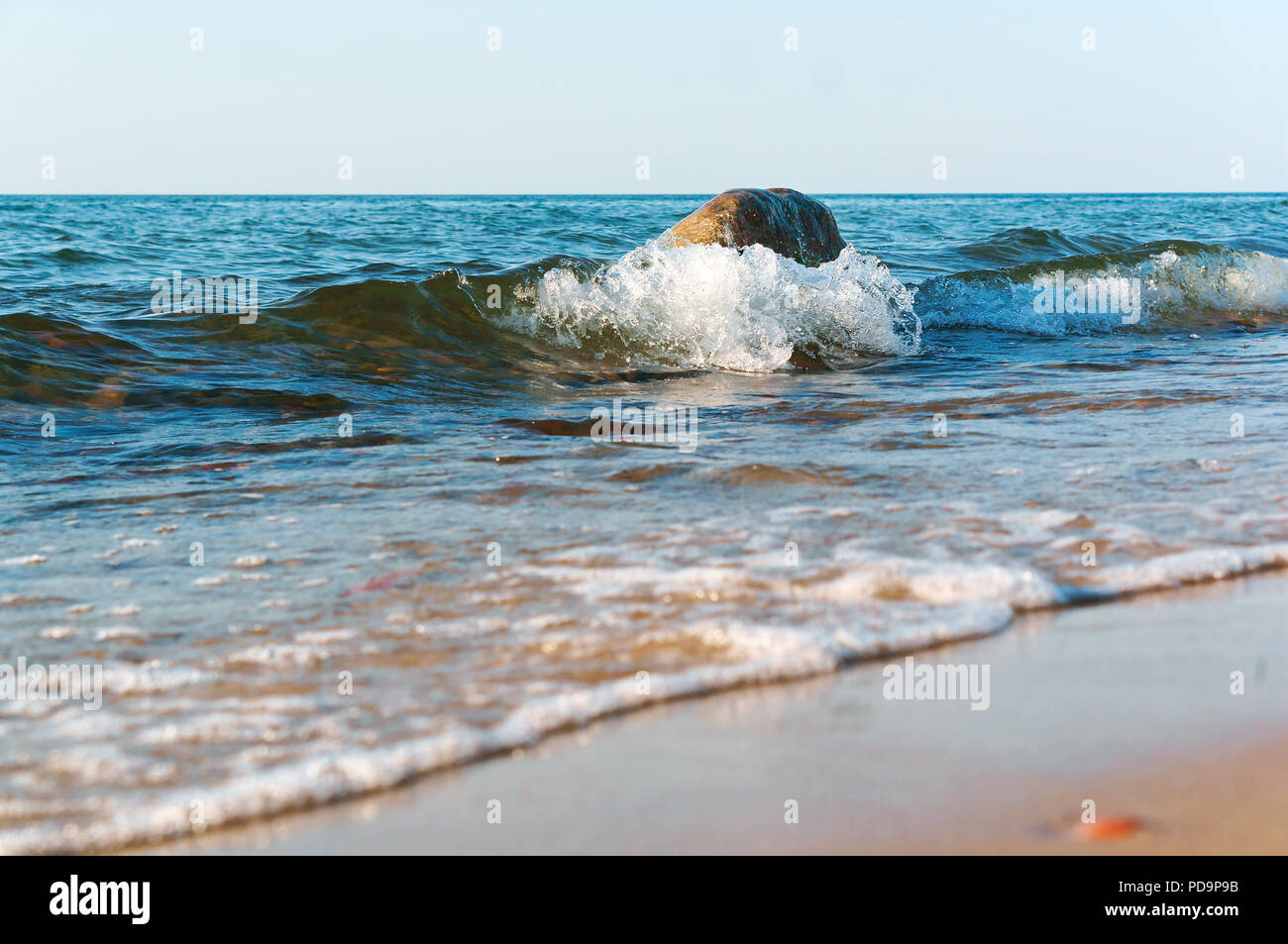 the sea wave hits the shore, the waves break on the coastal rocks Stock ...