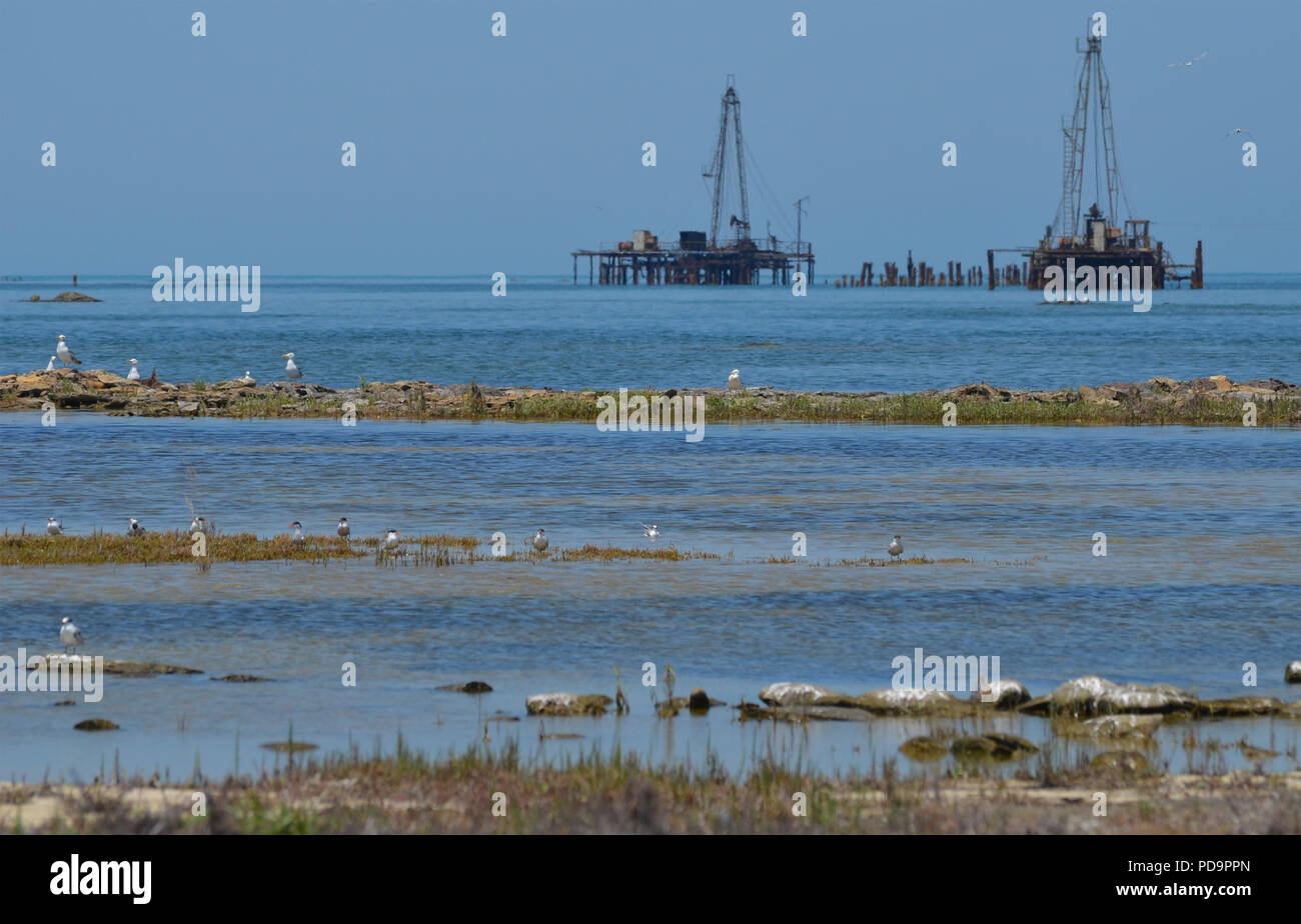 Caspian Sea pollution. Oil rigs close to the shore in Artyom island, Azerbaijan Stock Photo