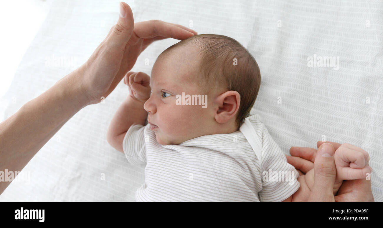 Mother stroking the child to feel the fontanel Stock Photo