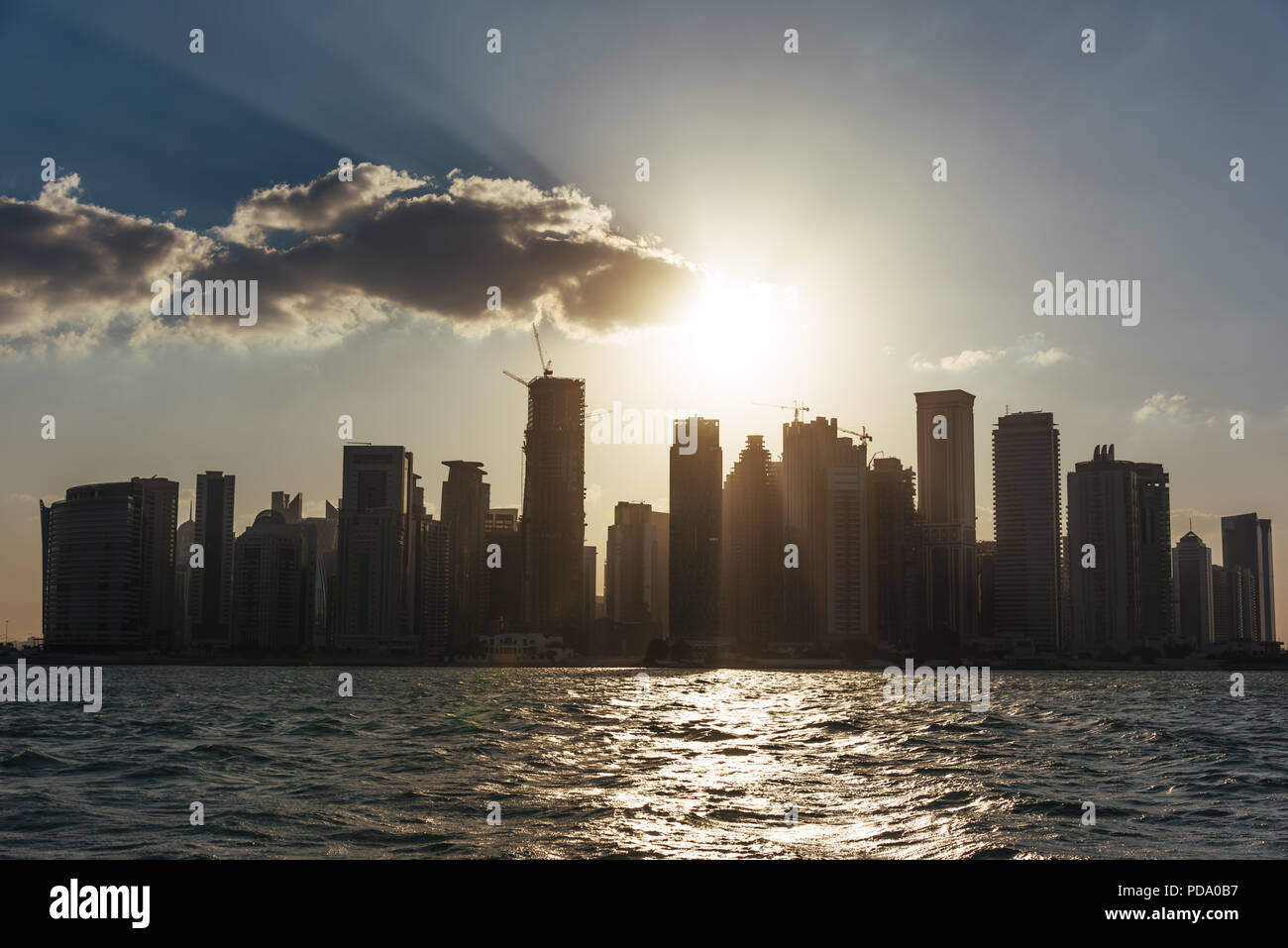 West Bay, downtown/CBD of Qatari capital Doha, from West Bay Lagoon, Persian Gulf, at sunset Stock Photo