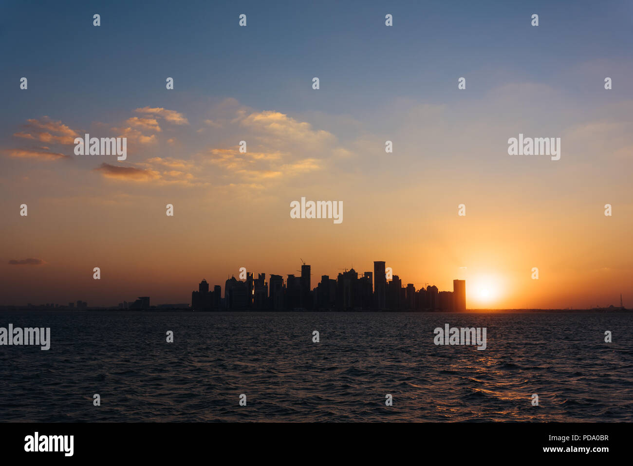 West Bay, downtown/CBD of Qatari capital Doha, from West Bay Lagoon, Persian Gulf, at sunset Stock Photo