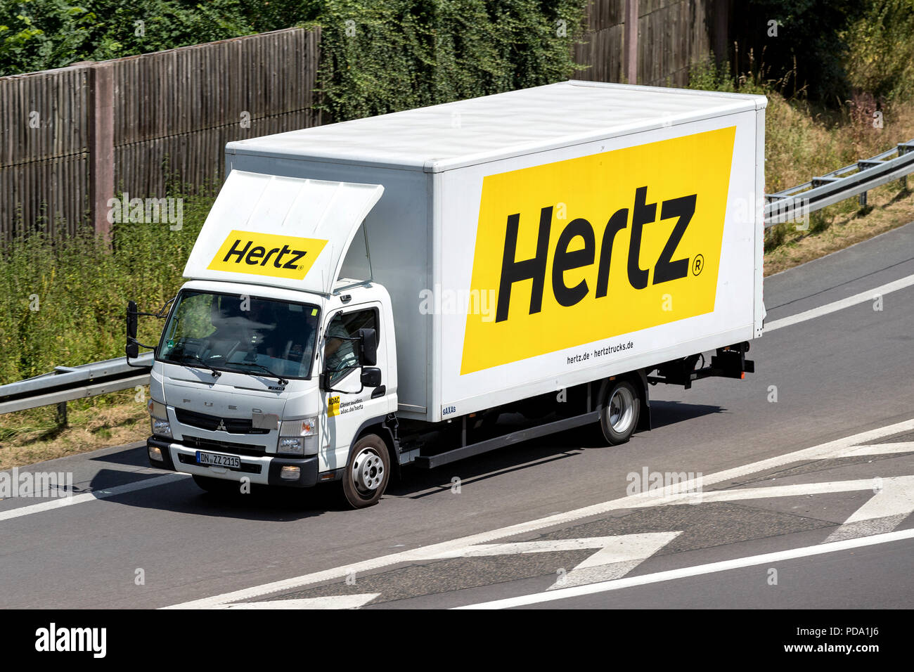 Mitsubishi Fuso Canter of Hertz on motorway. The Hertz Corporation is an American car rental company based in Estero, Florida. Stock Photo