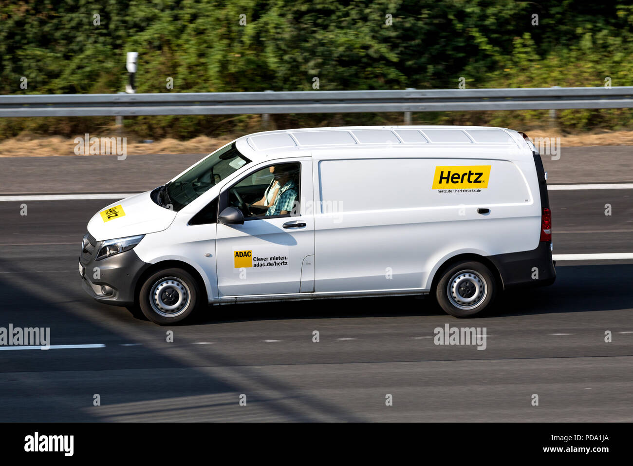 Mercedes-Benz Vito of Hertz on motorway. The Hertz Corporation is an American car rental company based in Estero, Florida. Stock Photo