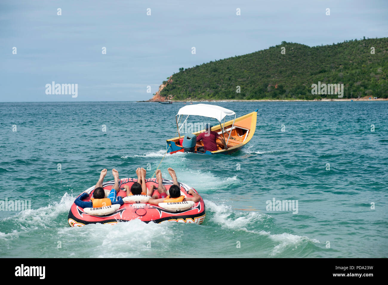 Circular Inflatable Boat Inflatable circular being towed behind a boat with people having fun ...