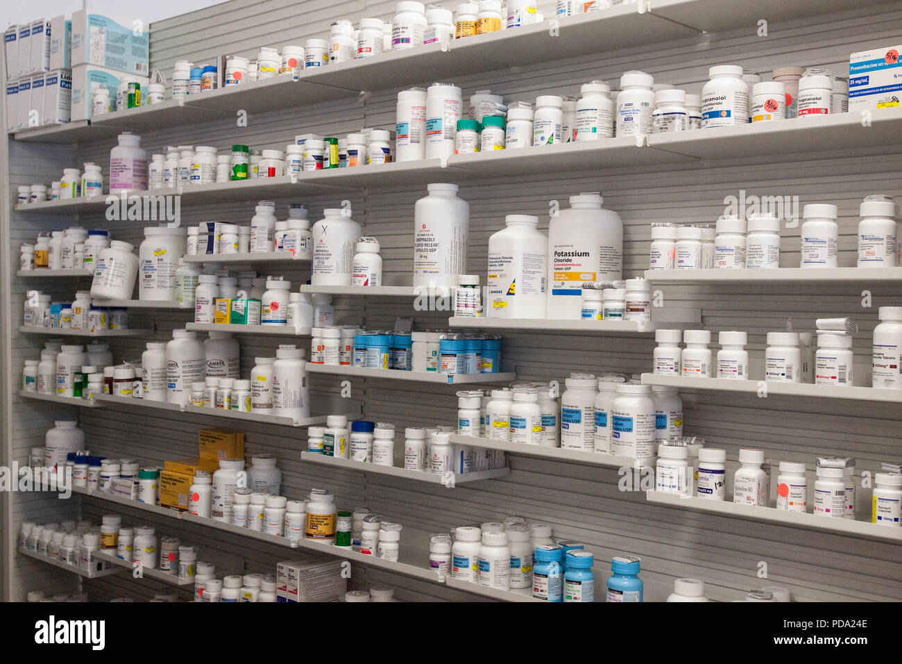 Medicines arranged on shelves at pharmacy Stock Photo