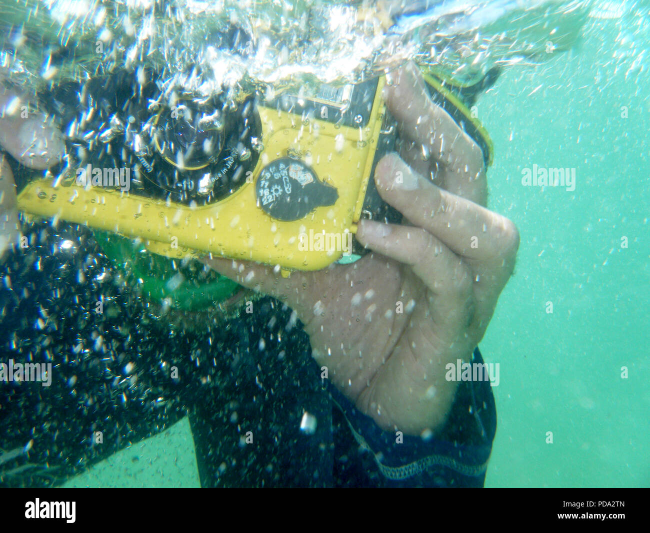 Underwaterphotographer. Diver taking a photograph underwater. Ocean