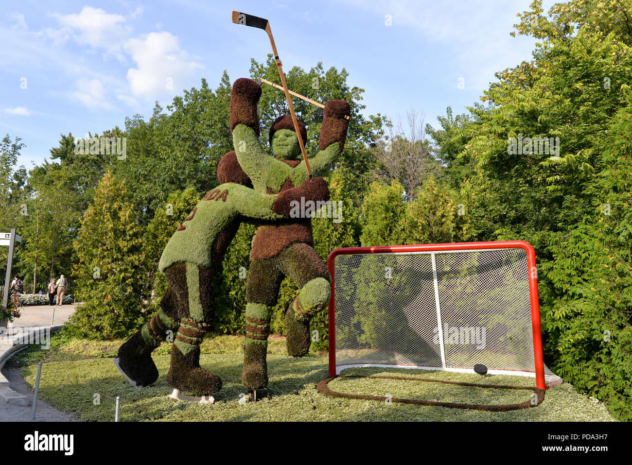 Quebec Garden Sculptures two hockey players having scored a goal