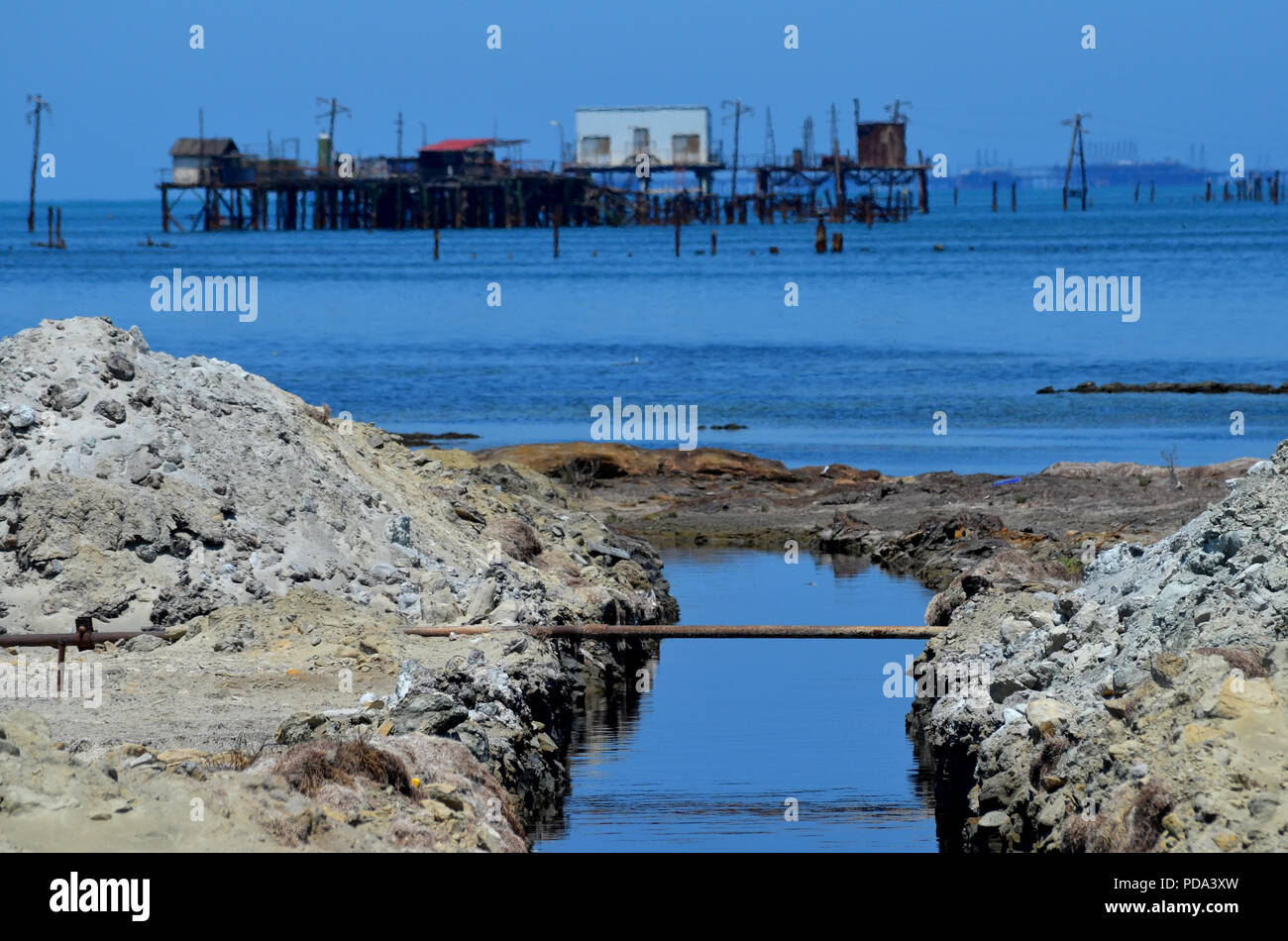 Caspian Sea pollution: a ditch discharges oily water into the sea, Absheron Peninsula, Azerbaijan Stock Photo