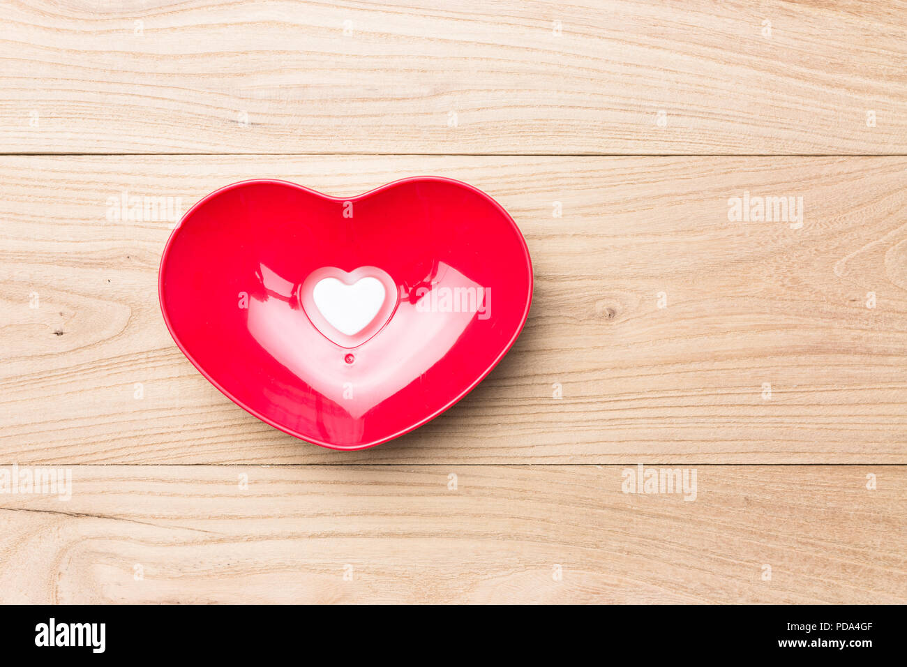 Heart shaped bowl in wood Stock Photo
