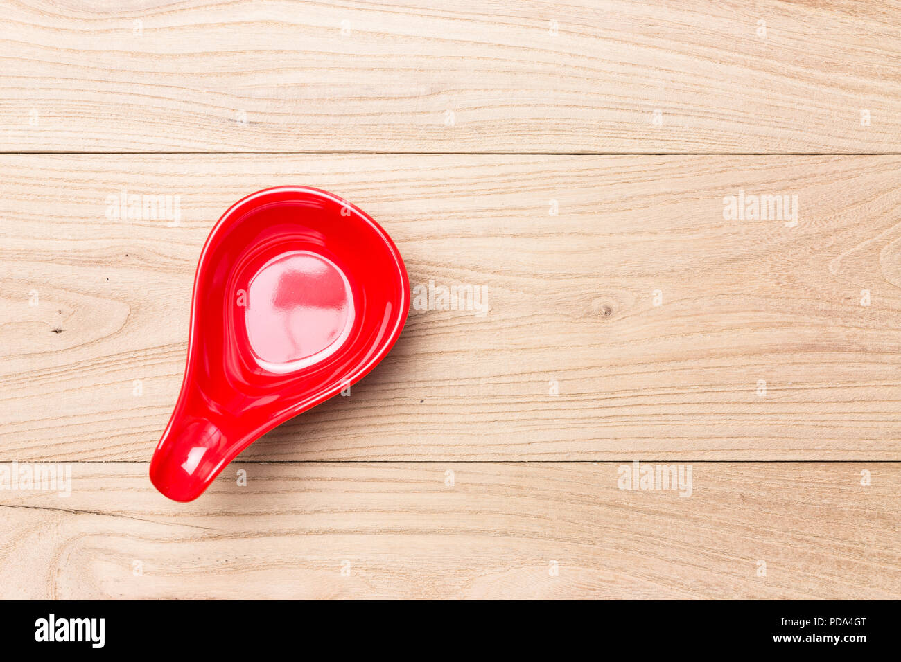 Red spoon in wood Stock Photo