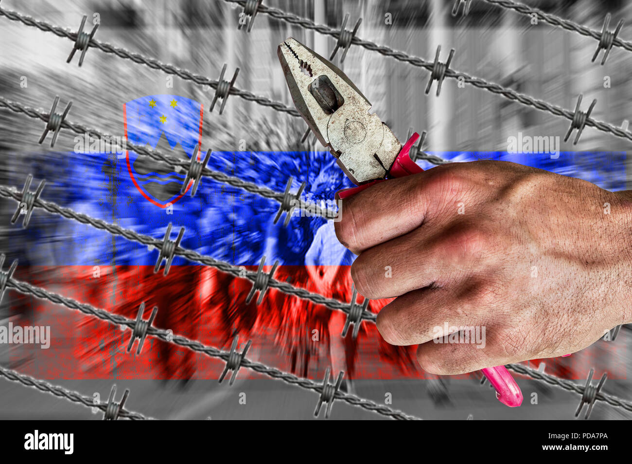 Slovenia flag, migrants, border house and barb wire with pliers Stock Photo