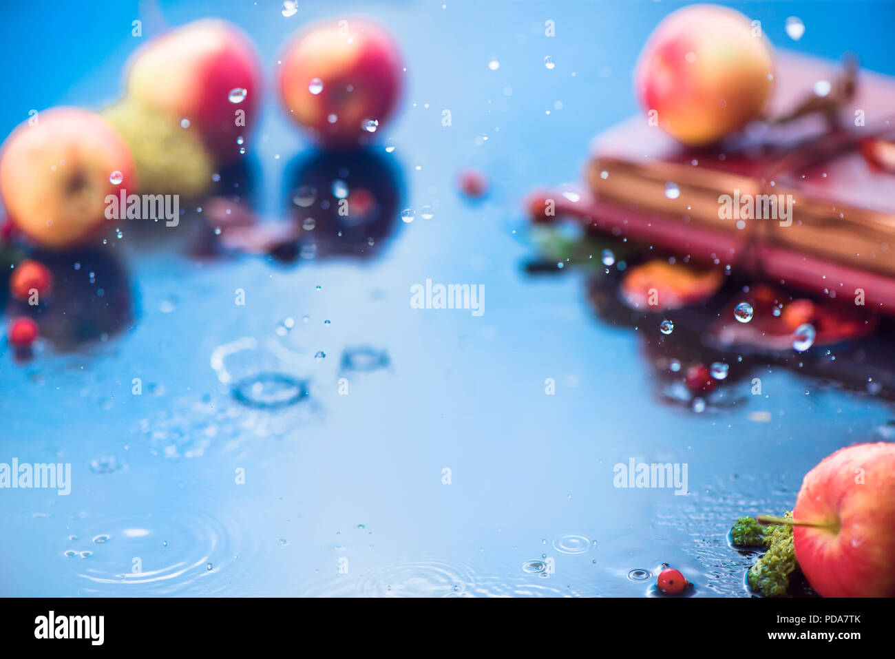 Autumn rain frame with copy space. Unfocused apples with water drops and place for text. Fresh and airy autumn harvest concept Stock Photo