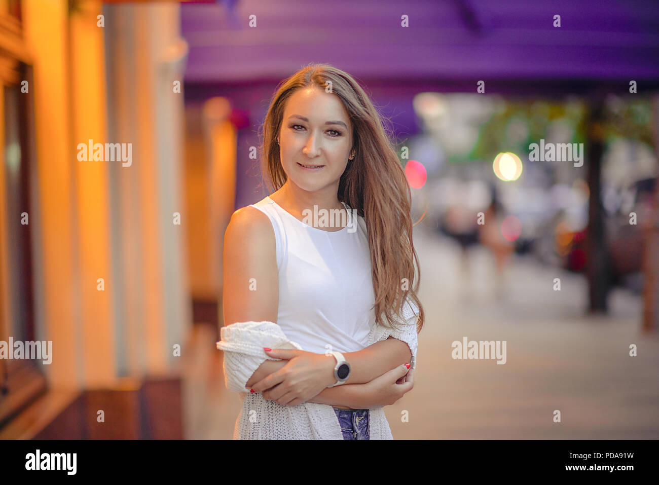 Girl sitting still and looking at camera with open eyes Stock Photo - Alamy