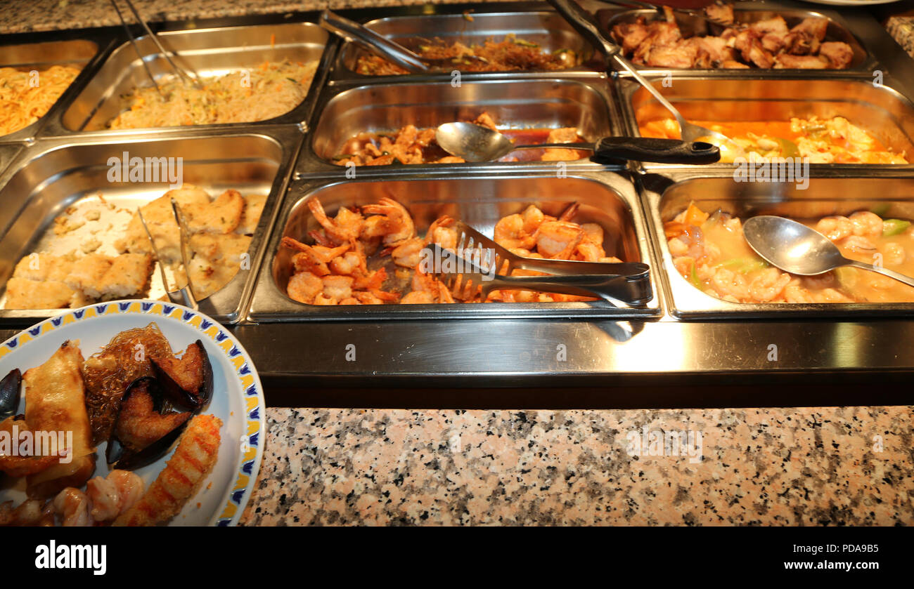 many fried foods in the trays of a self service all-you-can-eat ...