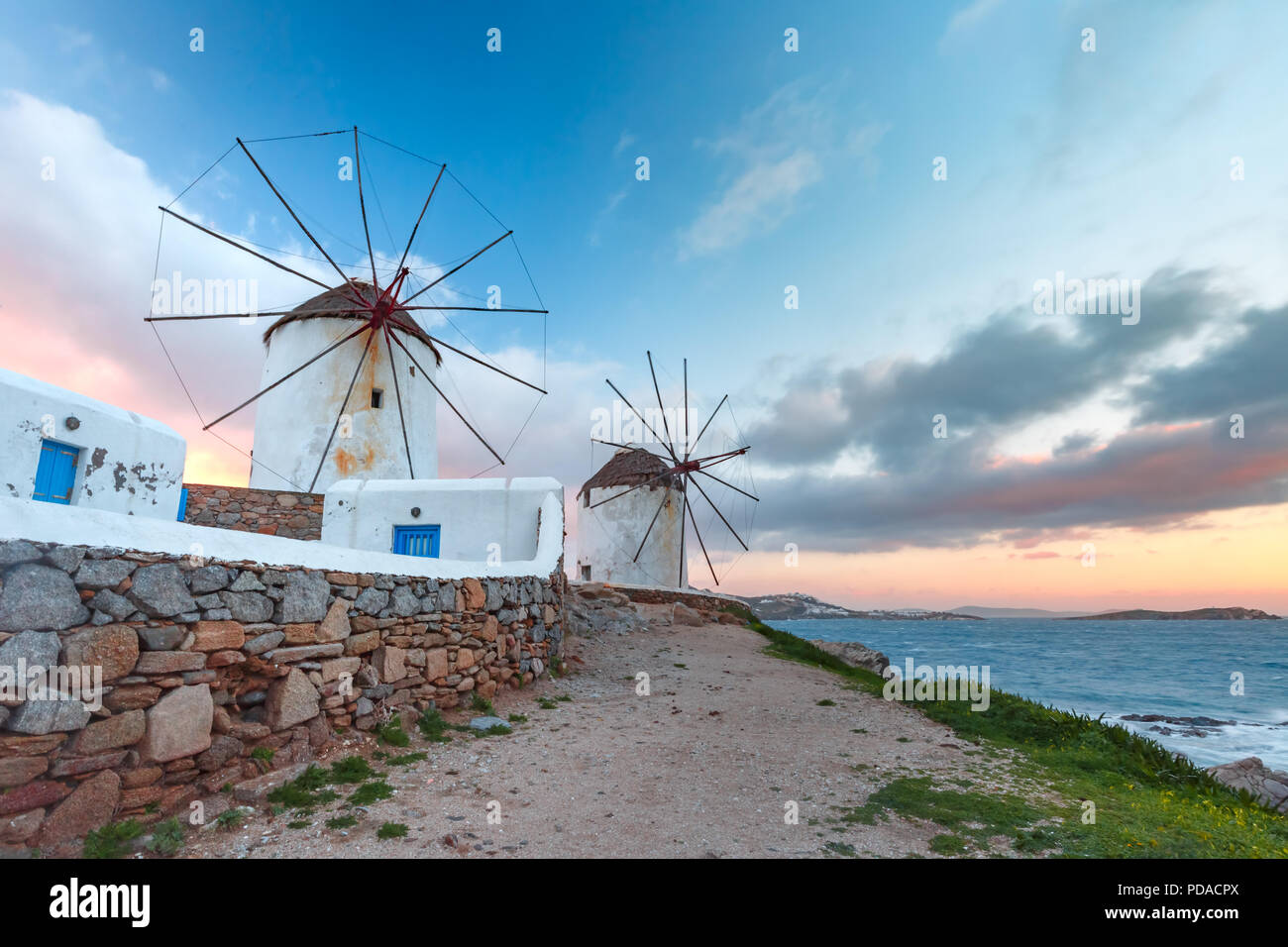 Traditional white windmills at sunrise, Mykonos, Greece Stock Photo