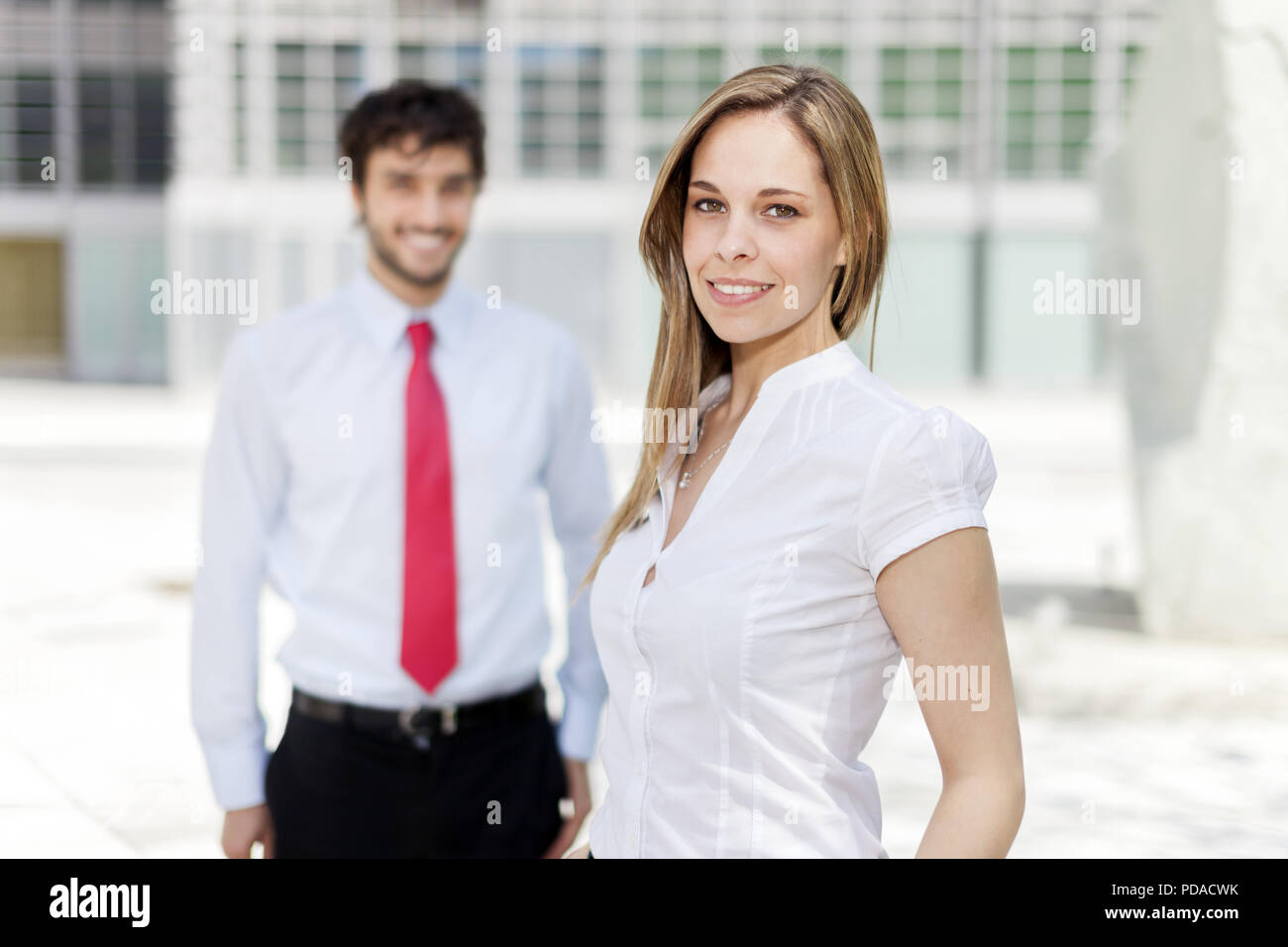 Portrait of a young smiling business woman Stock Photo - Alamy