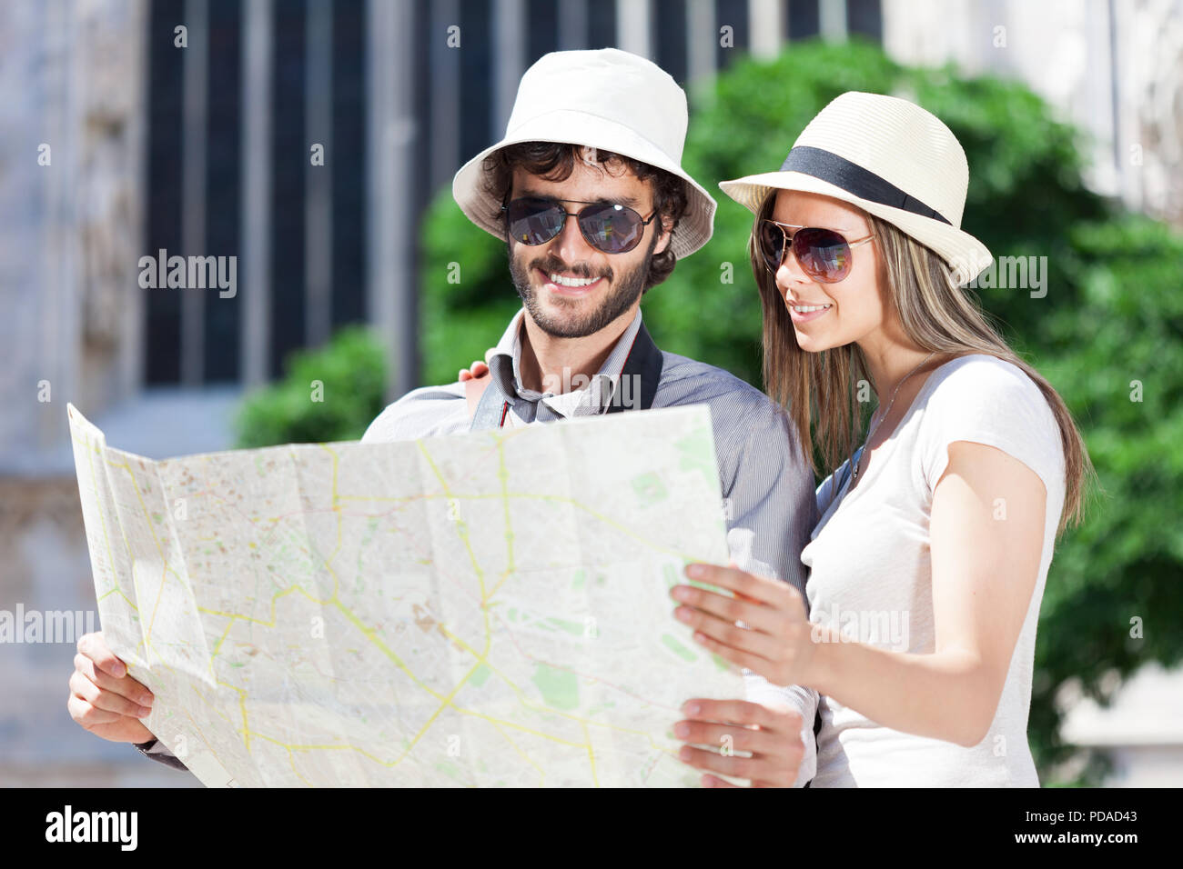 Couple of young tourists reading a map Stock Photo
