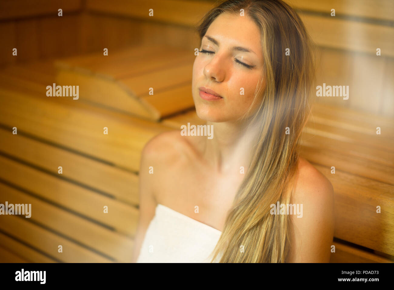 Beautiful woman having a sauna bath in a steam room Stock Photo - Alamy