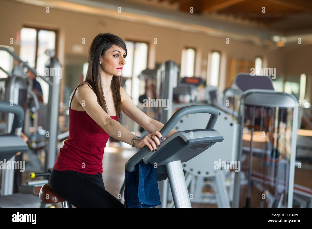 Woman working out on a stationary bike Stock Photo