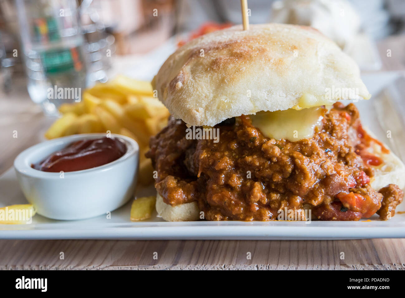 Chili hamburger, sauce and french fries in a mexican fast food Stock