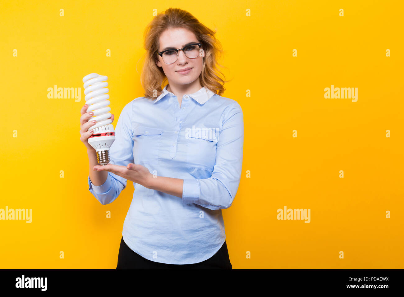 Attractive woman with energy saving bulb Stock Photo