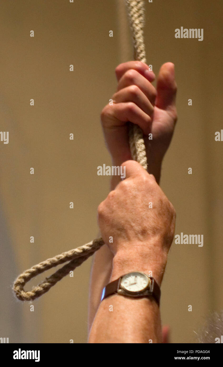 A bell ringer holds the tail-end of the rope as he ring a bell at St Mary's Church in North Mymms, Britain July 28, 2018. Stock Photo