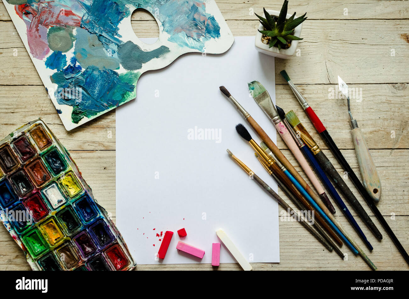 Creative artist workplace flat lay, mockup. Top view on table with blank  sheet of paper, paintbrushes and dye palettes. Art, workshop, painting,  drawi Stock Photo - Alamy