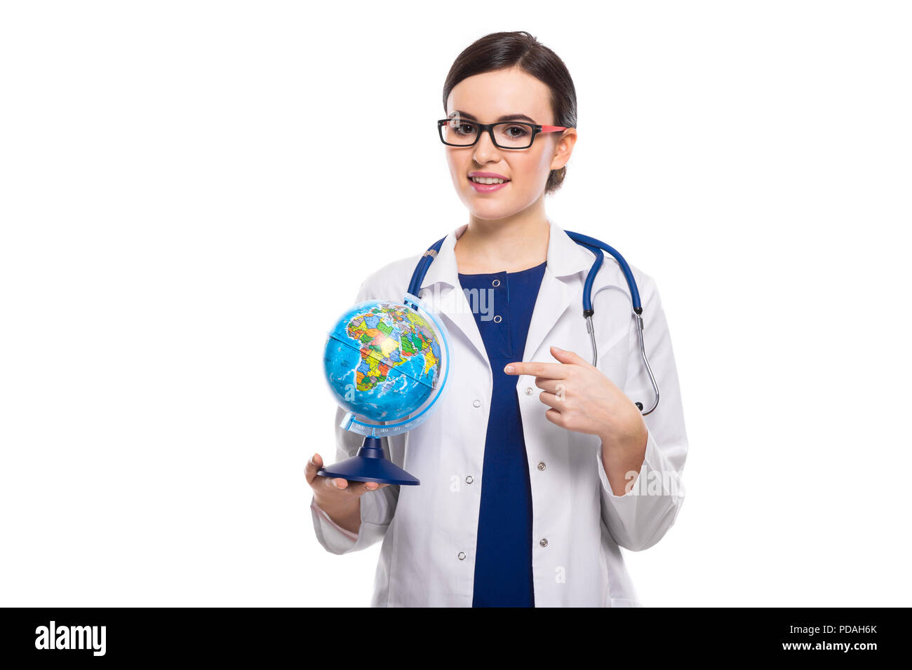 Young woman doctor with stethoscope holding a world globe in her hands ...