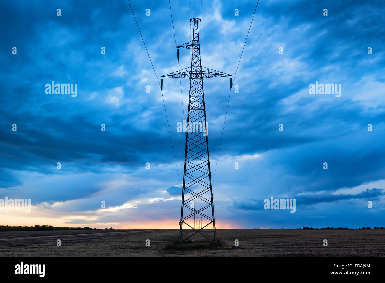 Rural landscape with electricity pole at sunrise Stock Photo - Alamy