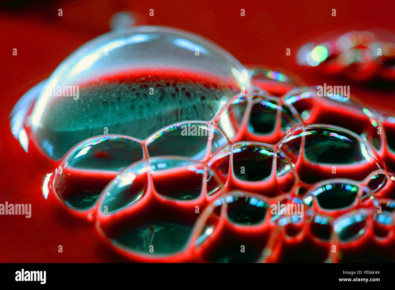 Blood bubbles on the surface of a dark red liquid Stock Photo