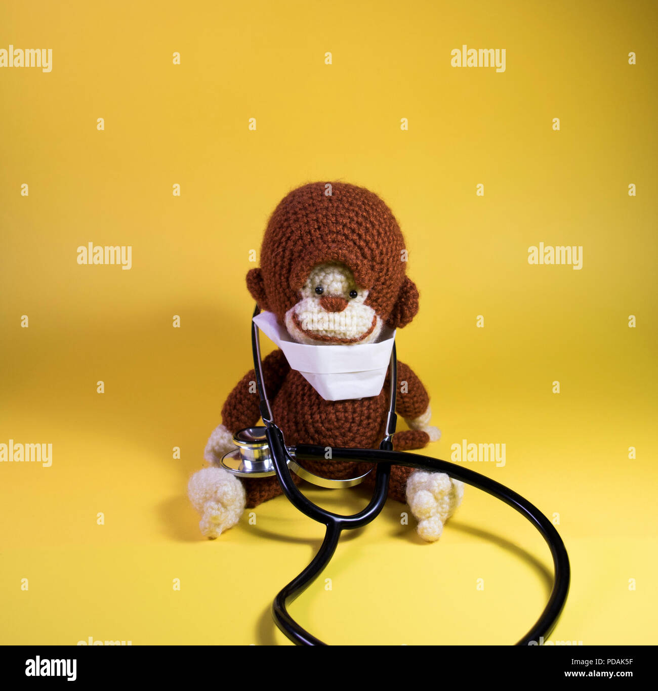 Medical Monkey stuffed toy panoramic. Cute plush brown monkey wearing a hospital mask and doctors stethoscope. Stock Photo